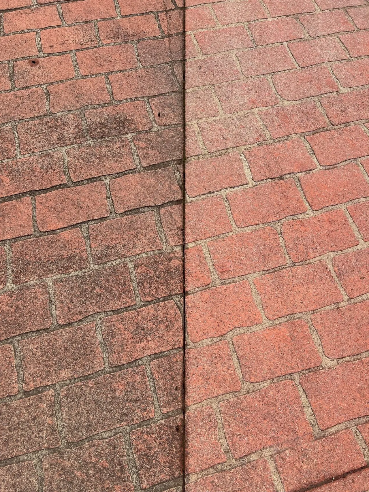 Before and after pressure washing of red brick paver driveway