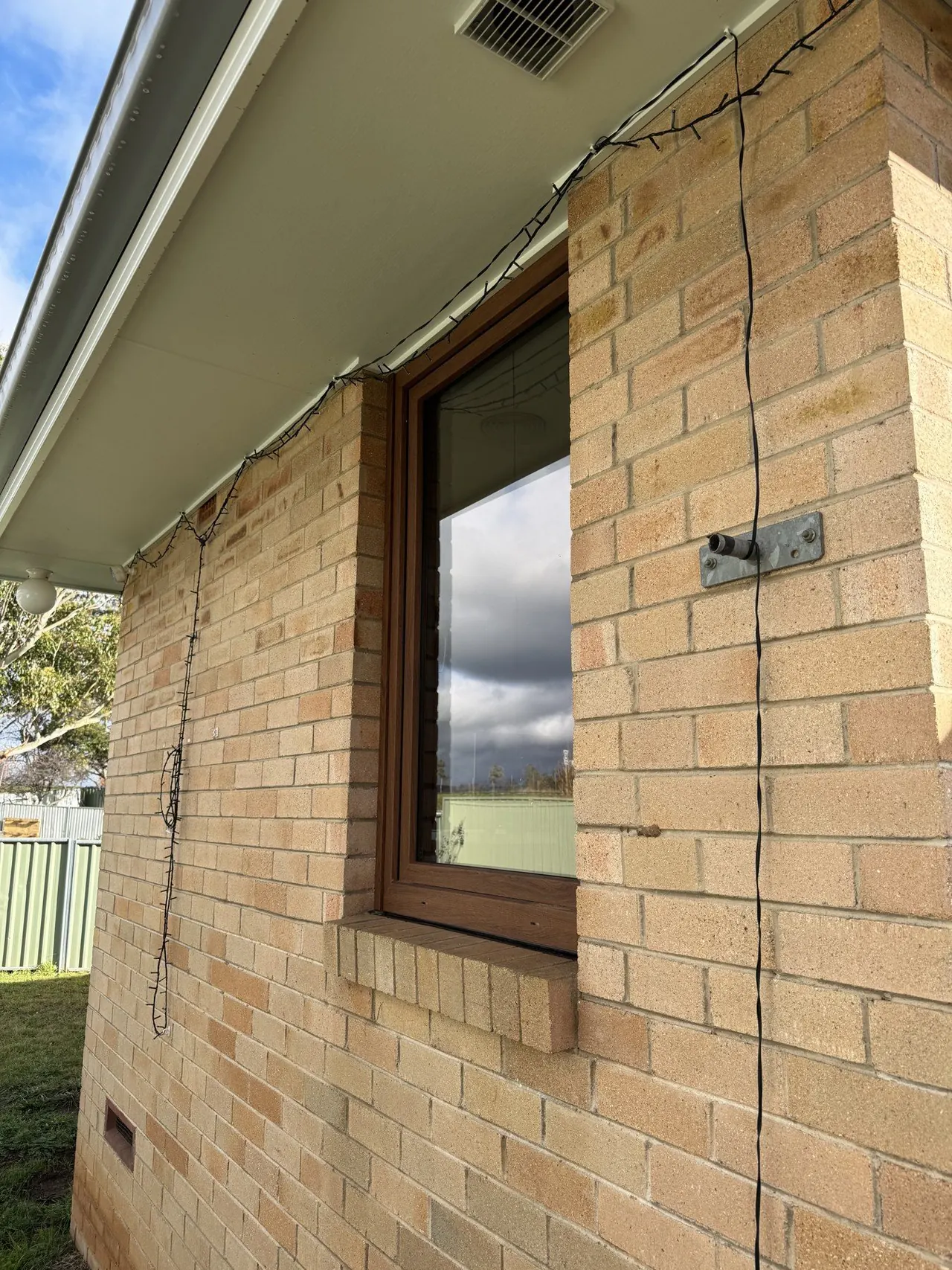 Freshly cleaned brick exterior window with streak-free glass